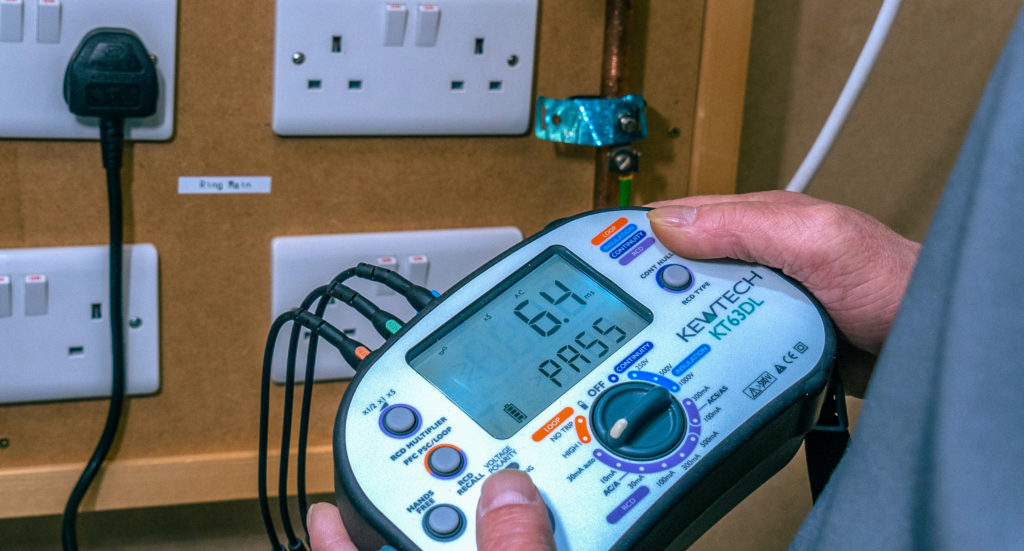 Electrician inspecting and testing electrical installations