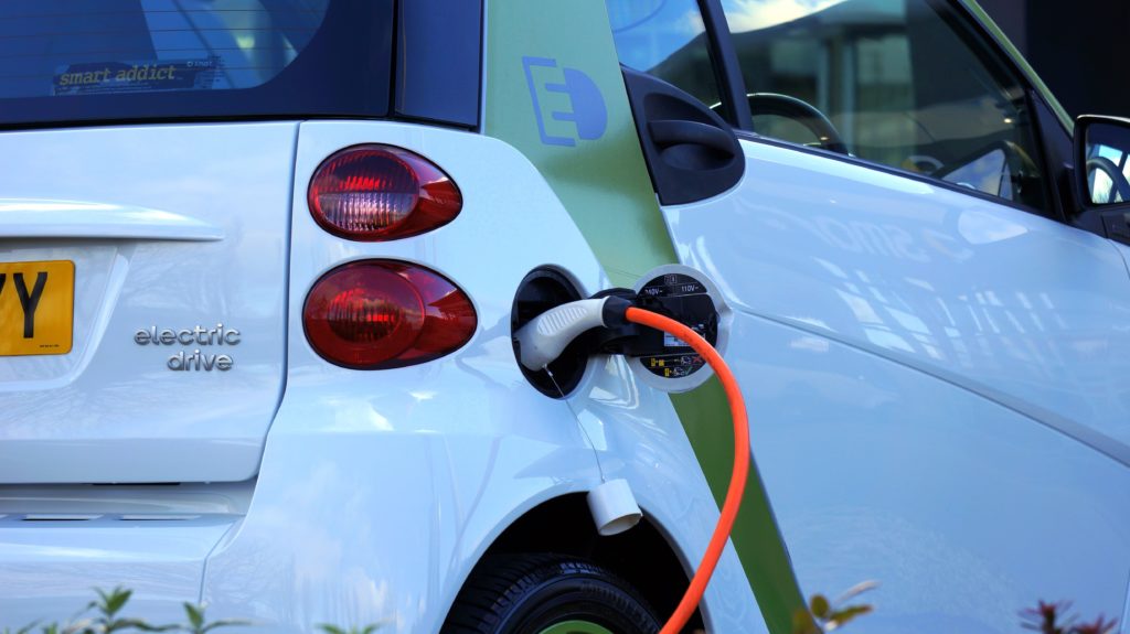 An electric car plugged in to an electric vehicle charging point